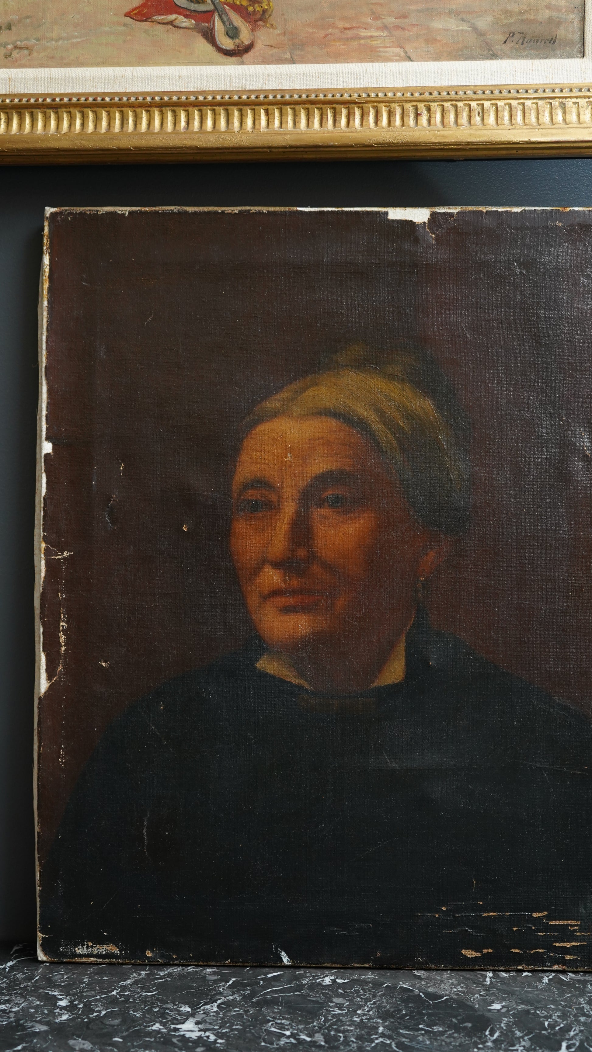 Small oil painting of a face with a dark frame