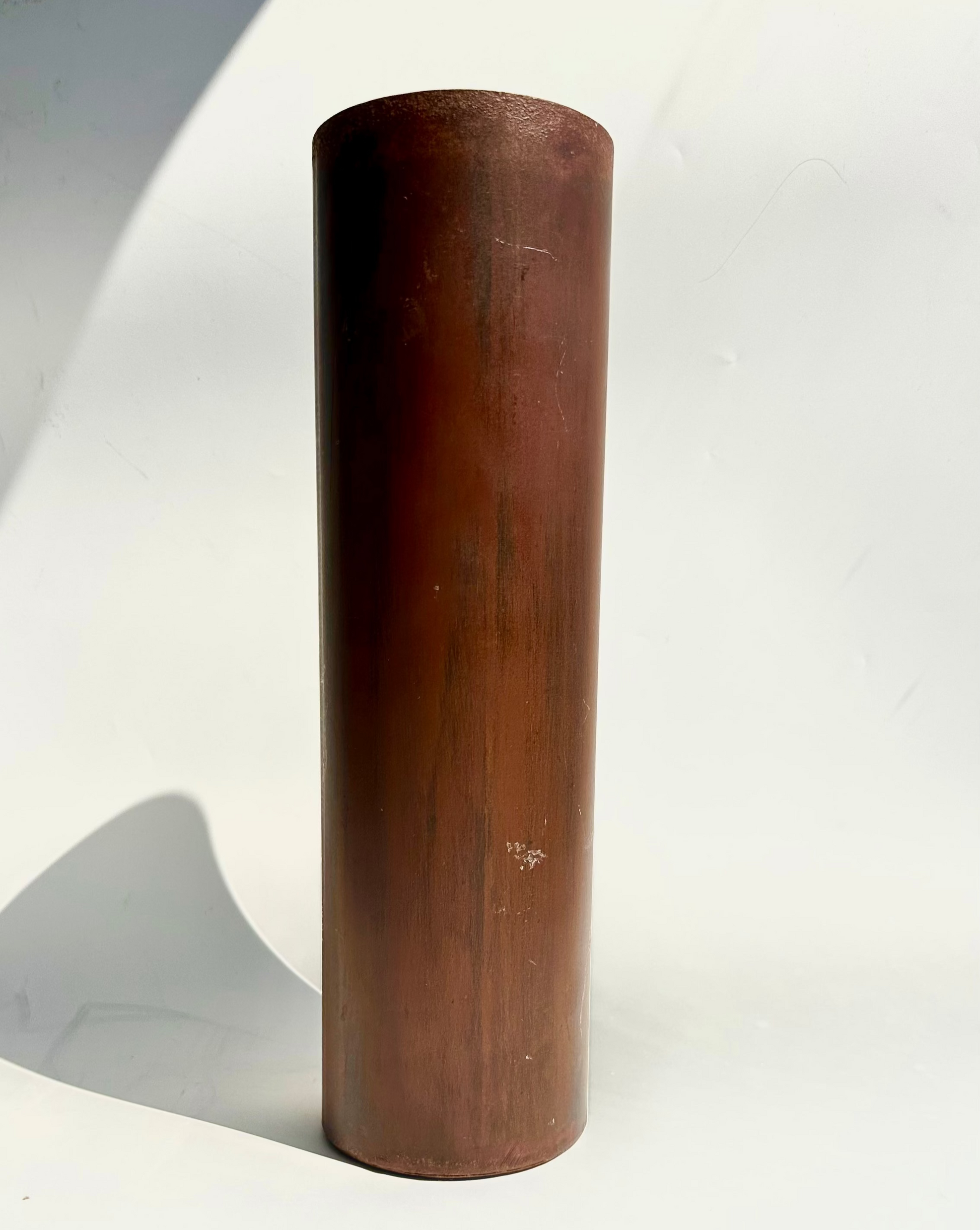 metal painted cylindrical vase on a white background