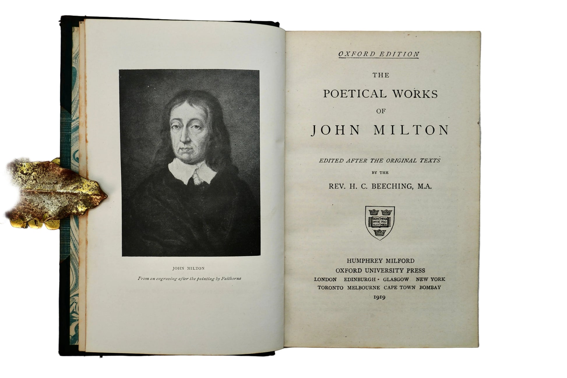 Open book titled 'The Poetical Works of John Milton' with a portrait on the page.