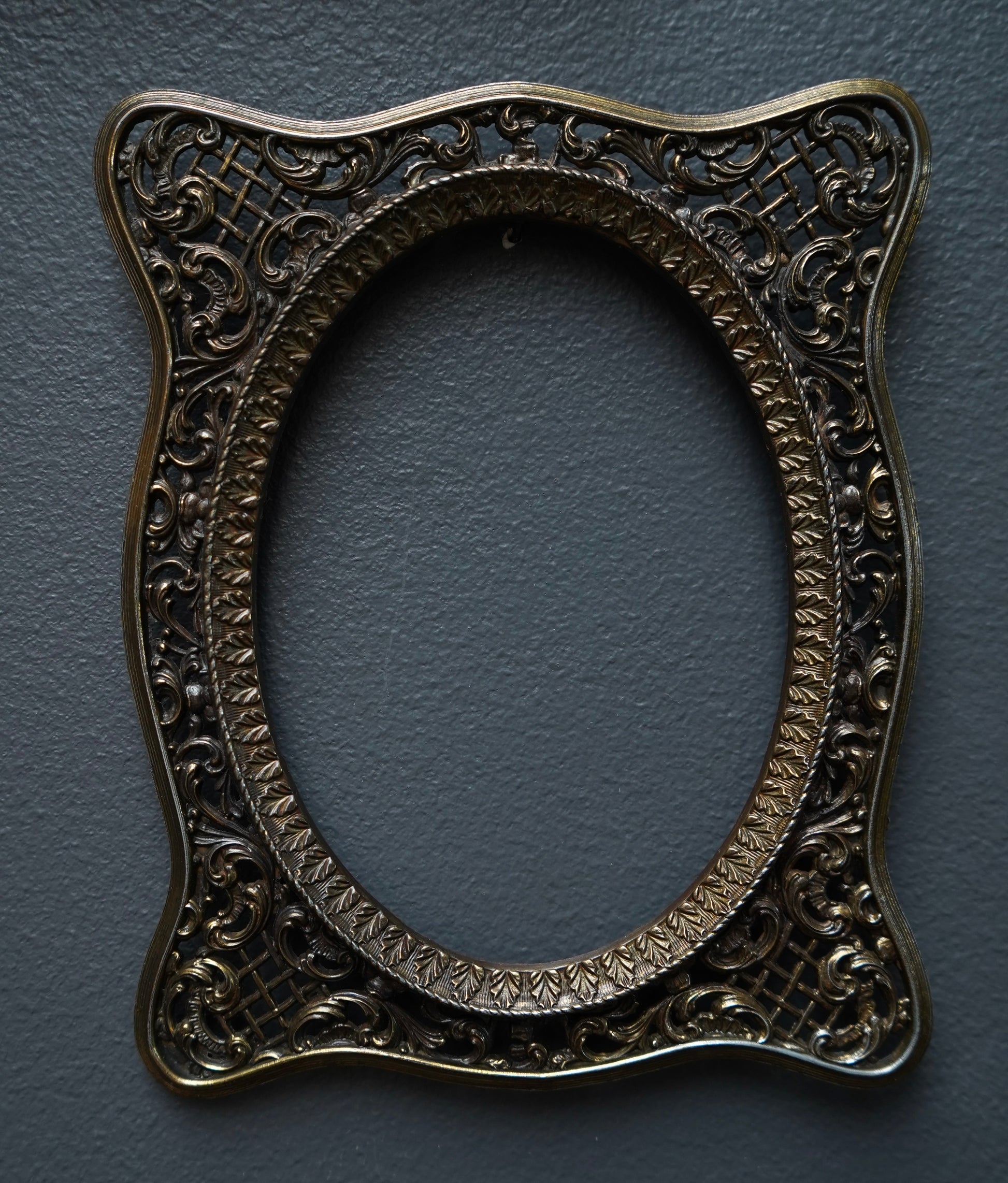Decorative oval frame with intricate patterns on a dark blue background