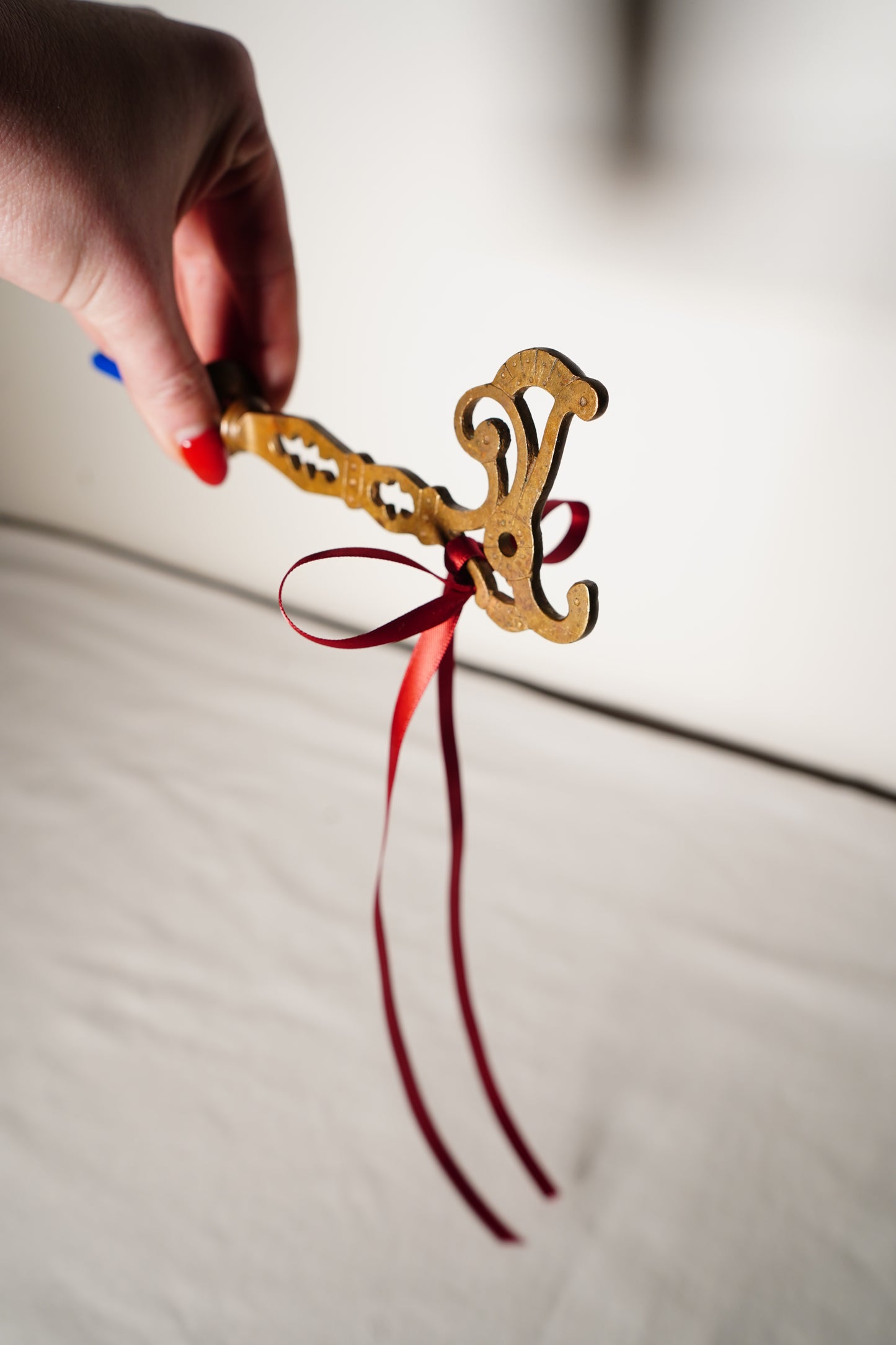 Pair of Ornate Brass French Curtain Rod Brackets with Scrollwork and Quatrefoil Piercing